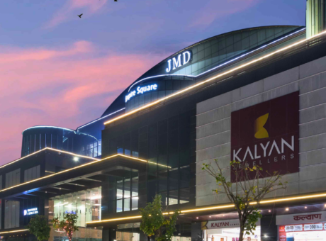 Night view of JMD Empire Square featuring Kalyan Jewellers, providing high-visibility commercial space for lease in a prime retail and business hub.