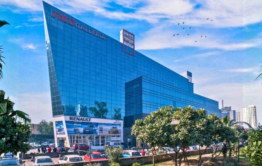 Exterior view of the glass-facade JMD Galleria building, an ideal location for businesses seeking premium commercial space for lease.