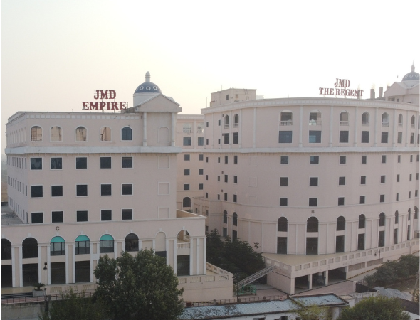 This is a JMD Empire building alongside JMD The Regent, displaying the massive scale of the corporate complex towers with distinct dome accents against a clear sky.