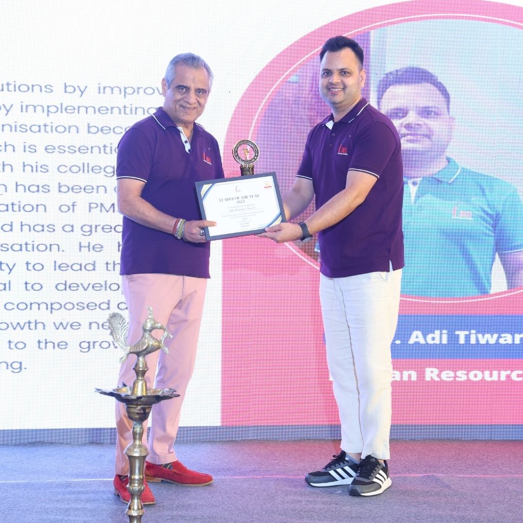 JMD Group Founder Mr. Sunil Bedi presenting a certificate of appreciation to Head of HR Department Mr. Adi Shankar Tiwari on stage at JMD Anuual Function 2025