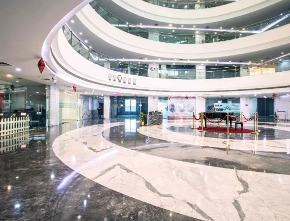 This is a JMD Megapolis building on Sohna Road Gurugram displaying a high-end corporate executive lobby lounge area, highlighting elegant visitor reception zones and luxury office space amenities.